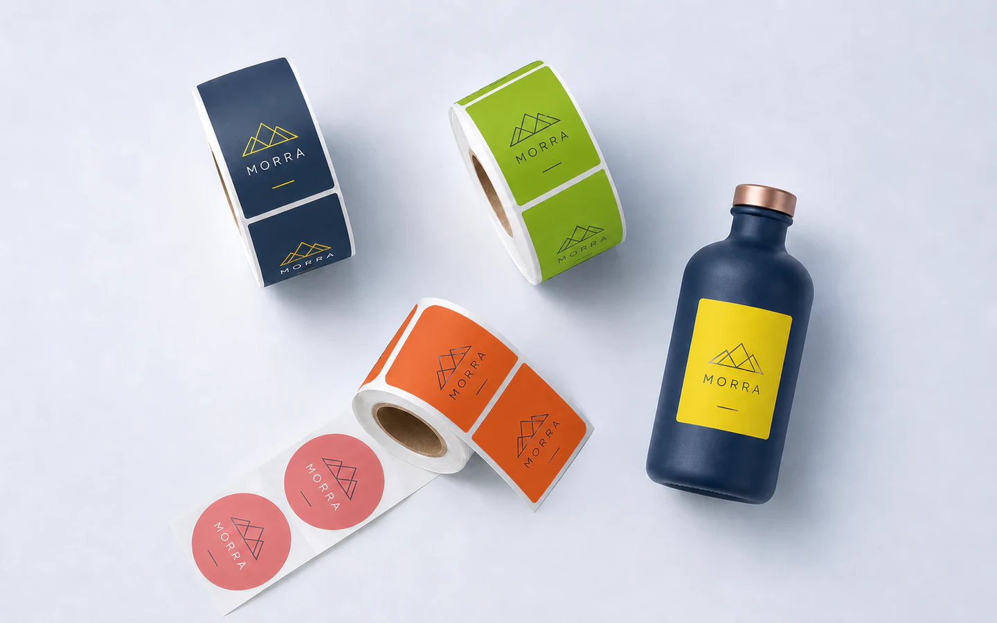MORRA product label rolls and a coordinated labeled bottle in an overhead arrangement