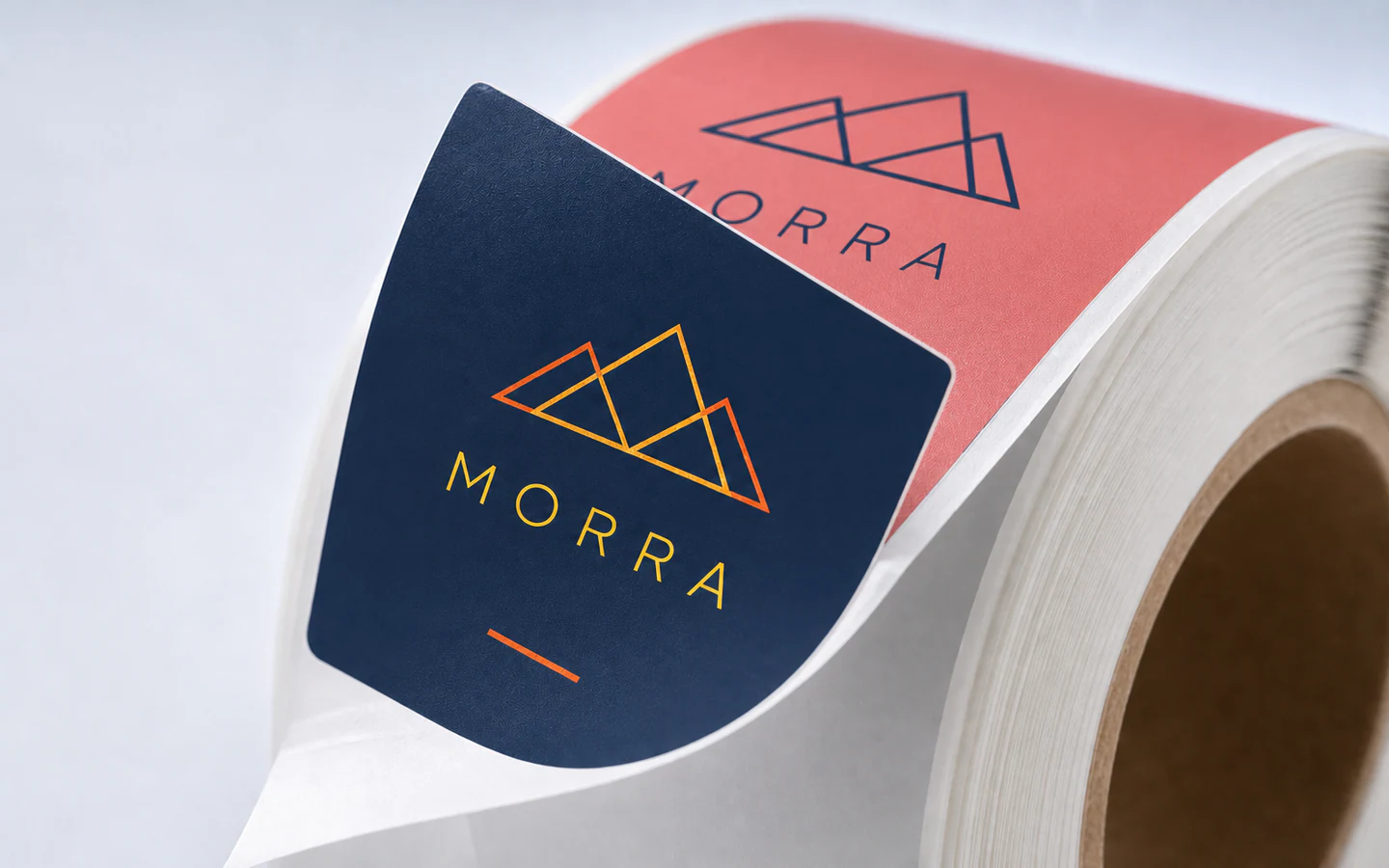 Macro view of a printed roll label peeling from its release liner